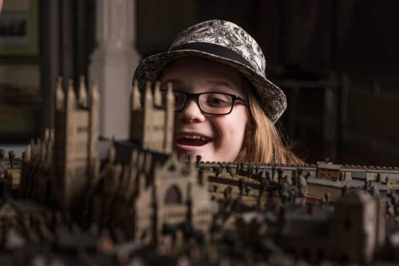 A young girl admires Caleb Hedgeland's model of Exeter