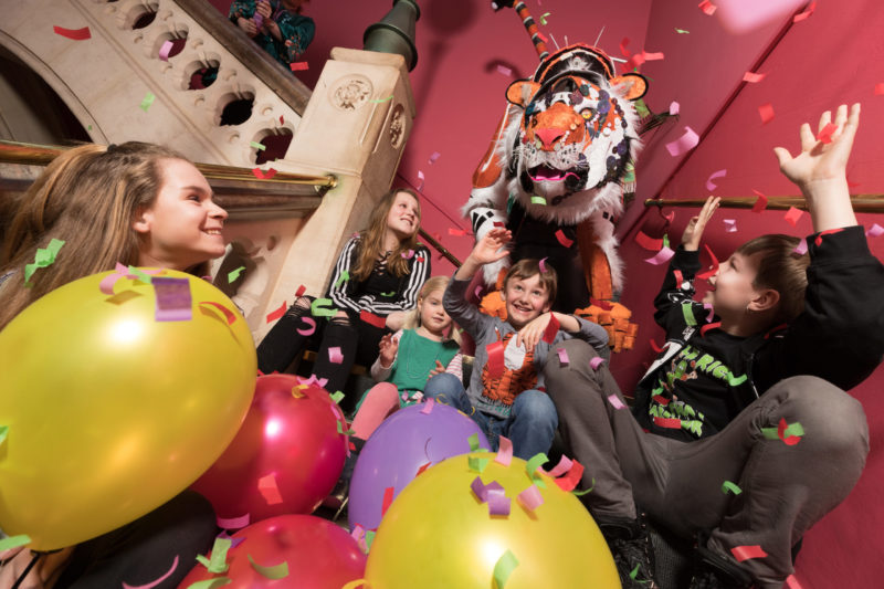 Children enjoy watching a puppet tiger display as part of Carnival of the Animals