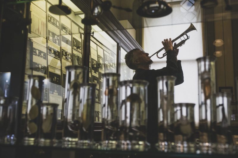 Musician plays trumpet in Sladen's Study gallery