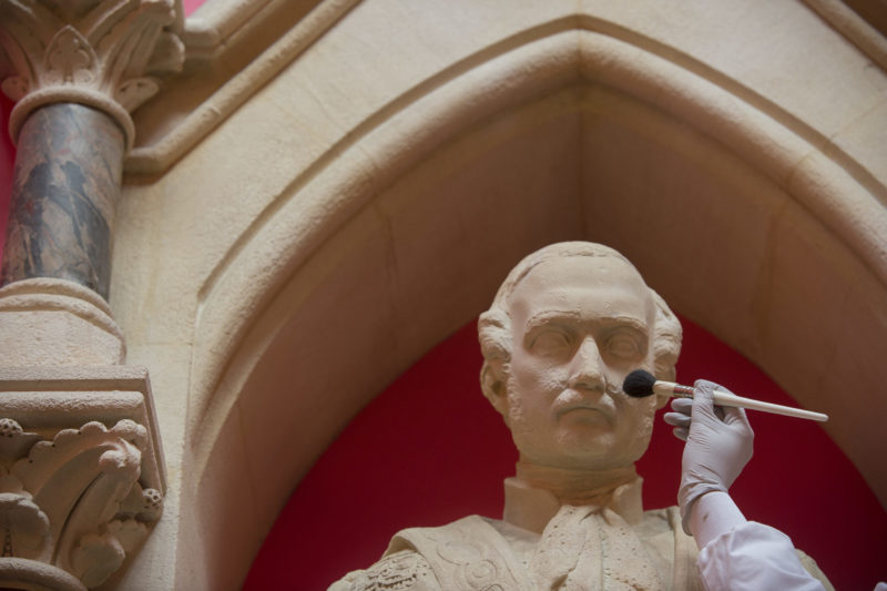 Albert statue being cleaned with a brush