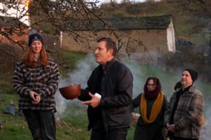 Group of people engage in Wassailing rituals