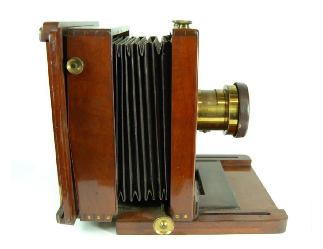 a 19th century portrait photography studio camera, made of wood and brass