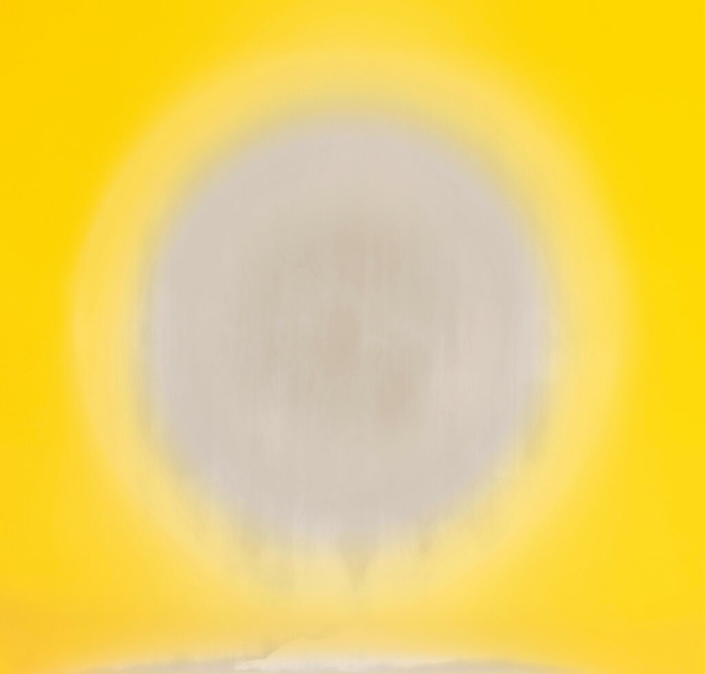 a white circle, blurred at the bottom, on a yellow background