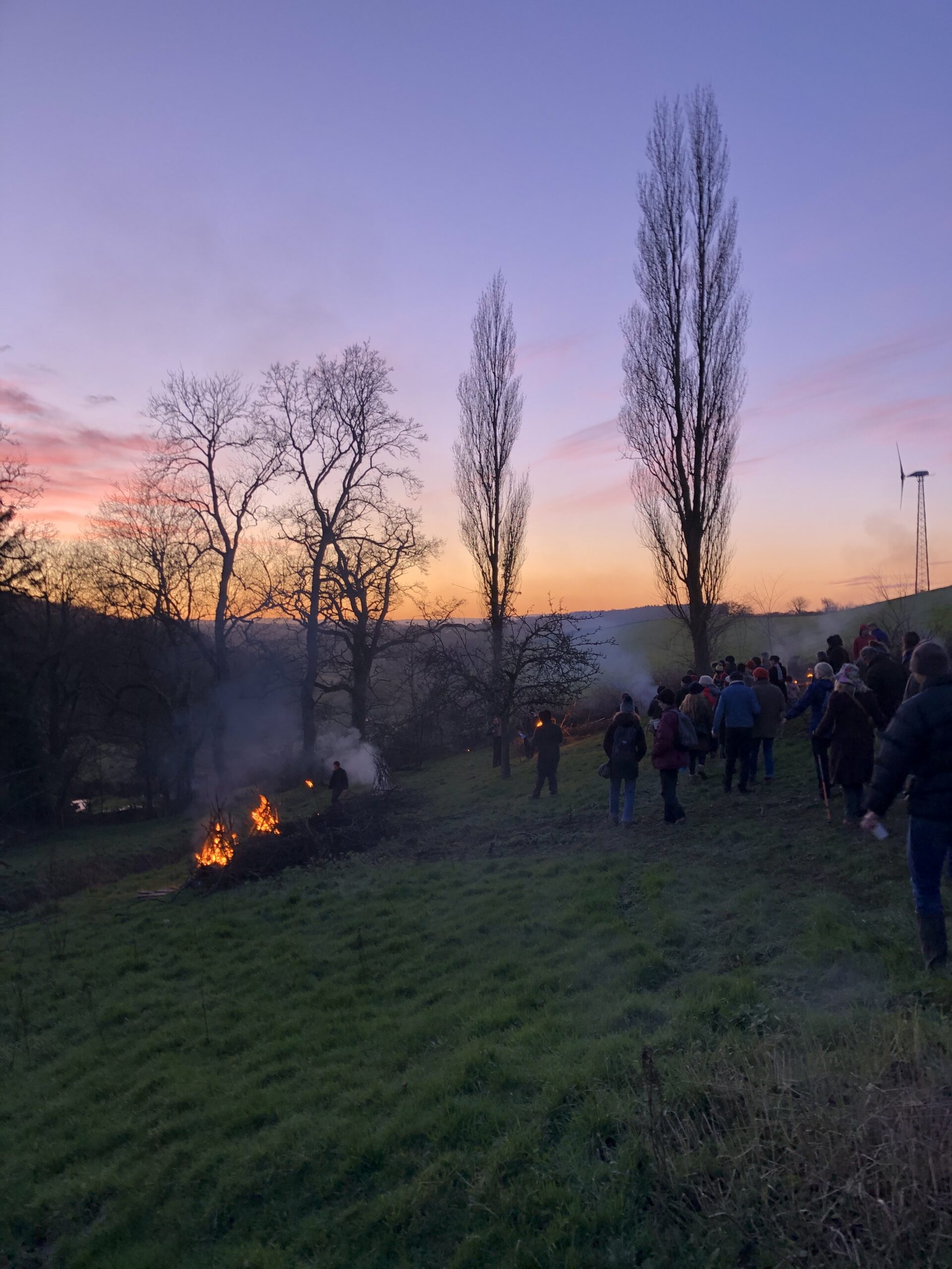 Simon Pope, Wassail, night time outdoor event with a sunset and fire.