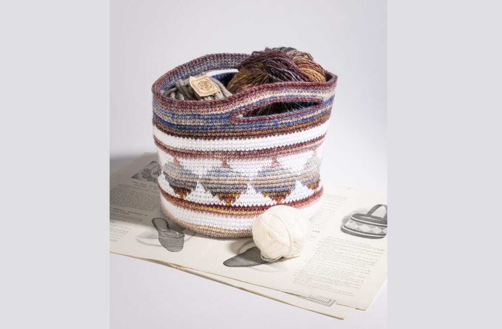 a crochet basket and ball of yarn