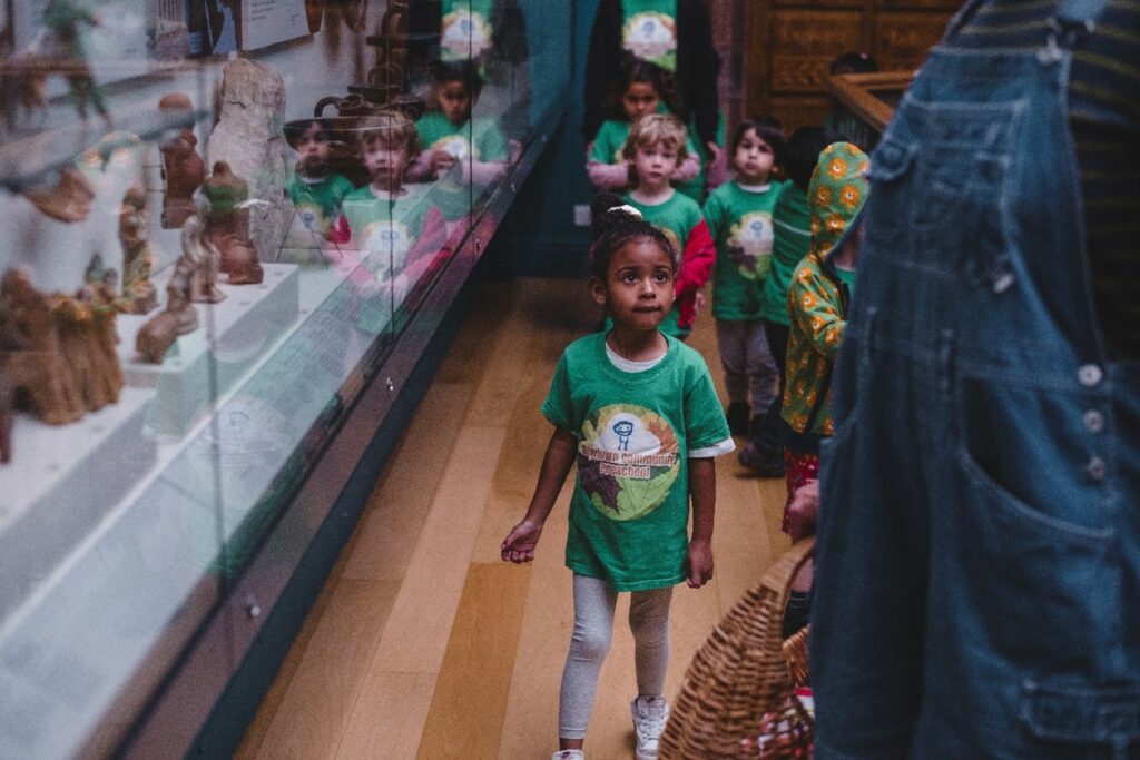 Young children walking around a museum