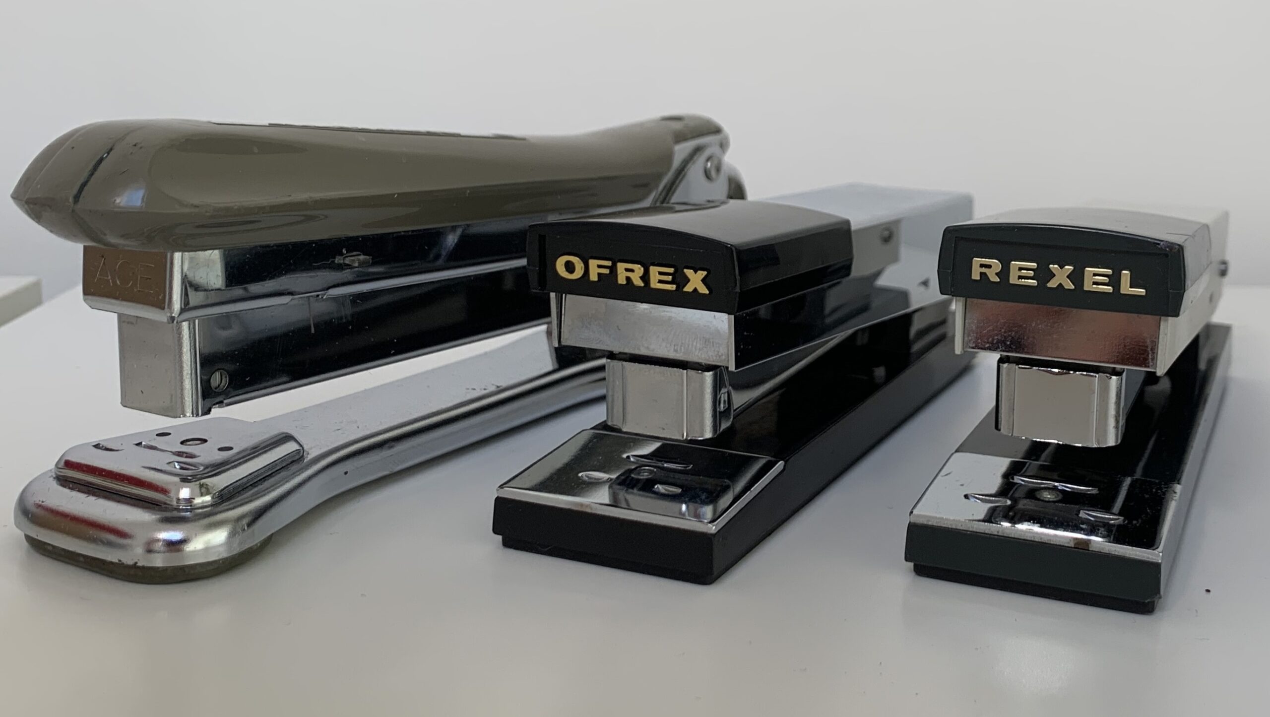 Three staplers lined up in a row